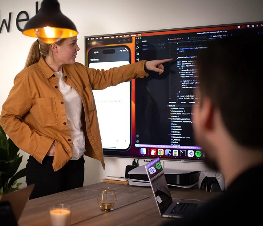Kvinna presenterar projekt på stor skärm.
